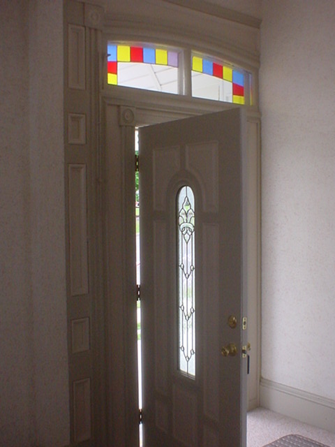 Beautiful stained glass and molding at the front door.
